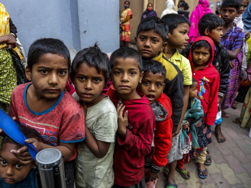 Homeless children stand in a queue to receive morning meal from Missionaries of Charity, the order founded by Saint Teresa, at the headquarter in Kolkata, India, Tuesday, Dec. 28, 2021. (AP Photo/Bikas Das)